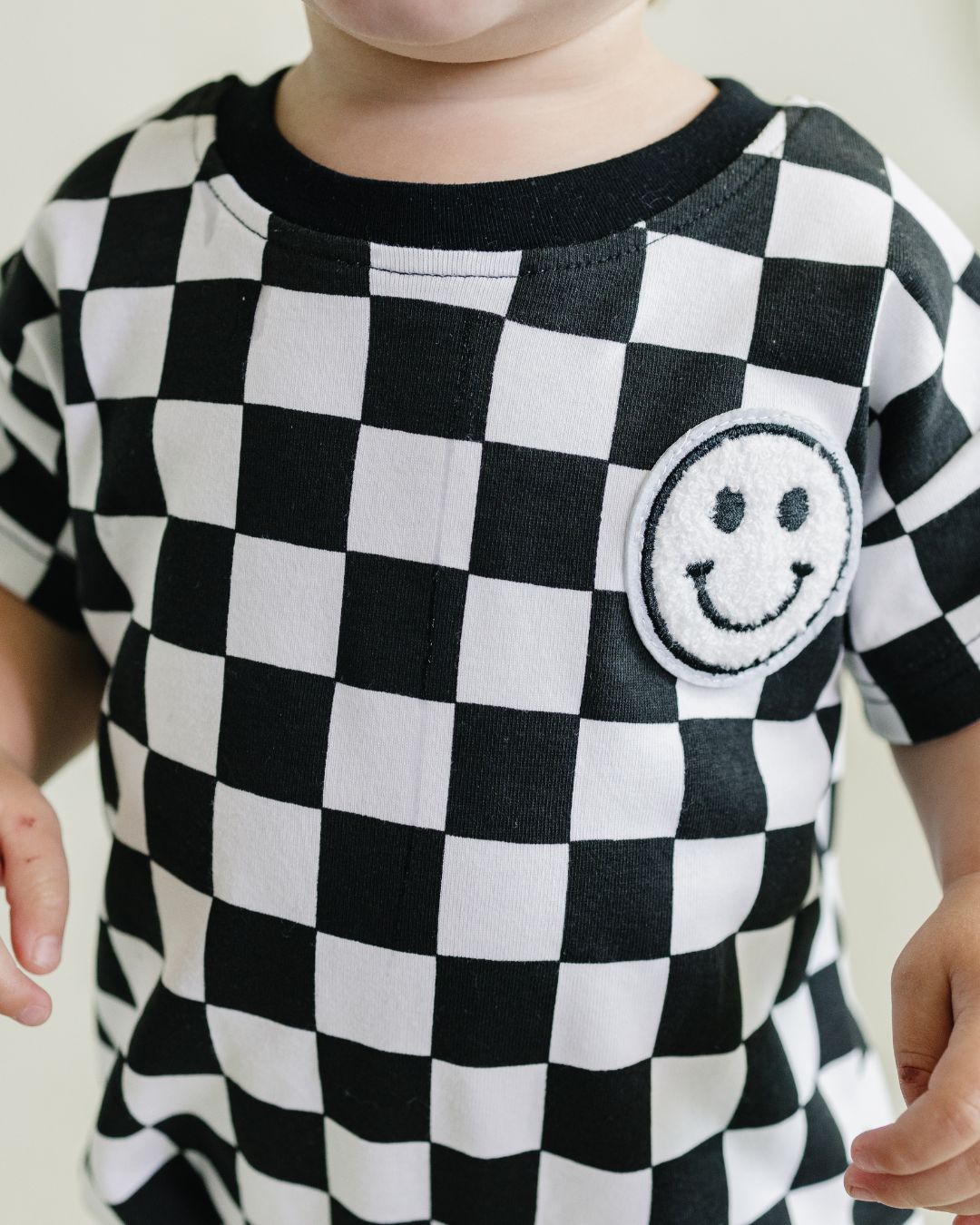 Short Sleeve Bubble Romper | Checkered Smiley Black - HoneyBug